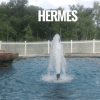 Hermes shallow water fountain producing a dynamic spray pattern in a pond."